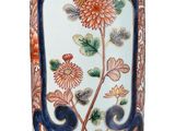 a vase with a floral design on it on a white background