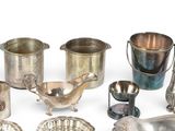 a lot of silver items sitting on a white surface