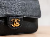 a close up of a black purse with gold hardware on it