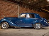 a blue car that is parked in a garage