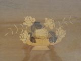 a painting of a cat sitting in a basket of flowers