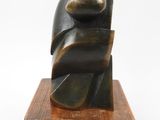 an image of a sculpture on a wooden base on a white background