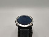 a close up of a watch with a black band and a blue dial