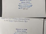 three white envelopes with blue writing on them sitting on a table