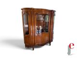 an image of a corner cabinet with a glass door