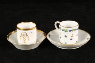 two cups and saucers sitting on a black surface