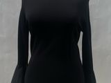 black and white top with bell sleeves on a mannequin dummy