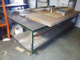 a workbench in the middle of a room with a lot of boxes on top of it