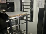 an image of a kitchen with a metal rack and a microwave