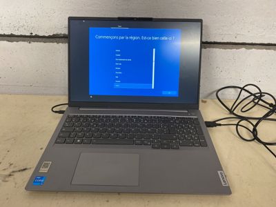 a laptop that is sitting on a table with wires