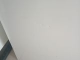 a picture of a corner of a bathroom with a toilet in it