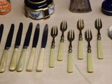 a lot of forks and spoons that are on the table