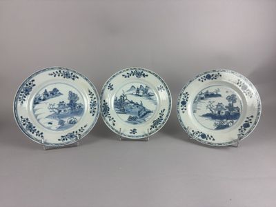 three blue and white plates with designs on them sitting on a table
