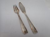 pair of silver plated forks and spoons on a white surface