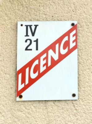 a red and white sign on the side of a building