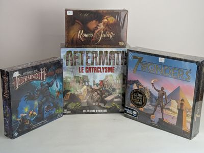 four board games sitting on top of each other on a table