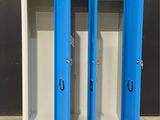two blue lockers with doors open in a room