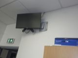 un téléviseur à écran plat fixé au mur d'une pièce