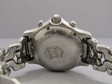 a close up of a watch with a chain around it