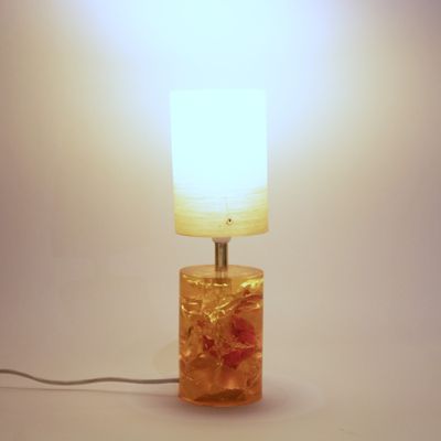 a lamp that is sitting on a table with a light on it