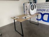 a table with a washing machine on it in front of a sign
