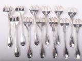 a lot of forks and spoons sitting on a table