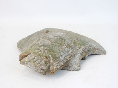 a stone object that is sitting on a white surface