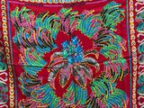 an image of a red cloth with a colorful design on it