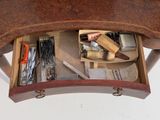 a wooden table with a drawer full of craft supplies