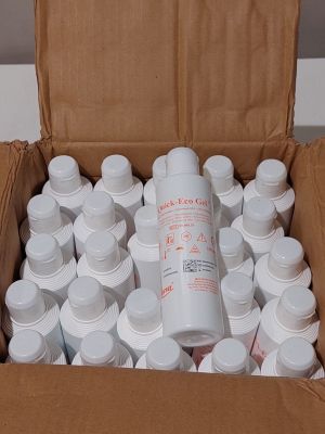 a cardboard box filled with white bottles and a bottle of water