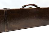 a brown suitcase that is sitting on a white surface