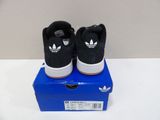 black and white adidas sneakers on top of a blue box