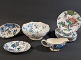 five different pieces of china on display on the table