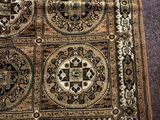 a rug on the floor with many different designs on it