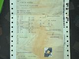 a receipt sitting on the seat of a car next to a pair of scissors