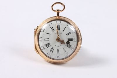 a gold pocket watch with roman numerals on the face