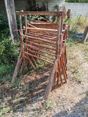 a pile of wooden sticks sitting in the grass