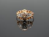 an image of a gold and diamond ring on a reflective surface