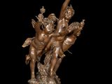 bronze statue of a group of cherensils on a marble base