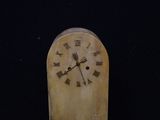 a wooden clock with roman numerals on the face