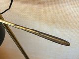 a pair of scissors sitting on a table next to a lamp
