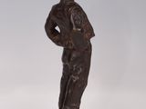 bronze figurine of a boy in a sailor ' s uniform