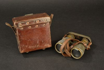 two binoculars sitting next to each other on a black surface
