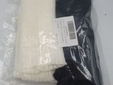 two pairs of socks in a plastic bag on a table