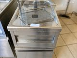 a deep fryer sitting on top of a counter in a kitchen