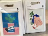 two boxes with a picture of a woman sitting on top of a wooden table