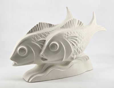two white fish that are sitting on a white surface
