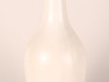 a white vase that is sitting on a table
