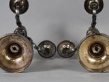 pair of antique silver candlesticks on a white background