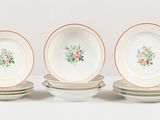 four plates with flowers on them on a table